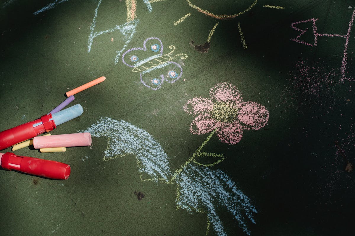 Photo of sidewalk chalk, flowers, kid art.